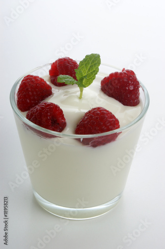 some organic raspberries in natural yogurt and mint