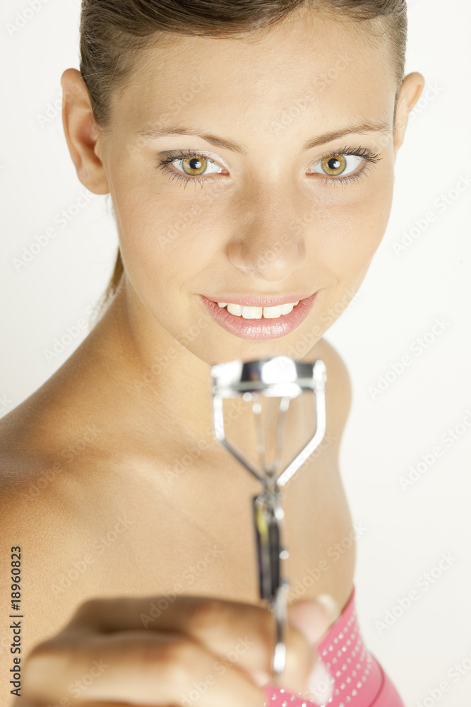 portrait of young woman with eyelash tweezers portrait of young woman with eyelash tweezers