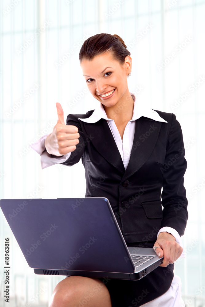 pretty business woman looking at laptop..