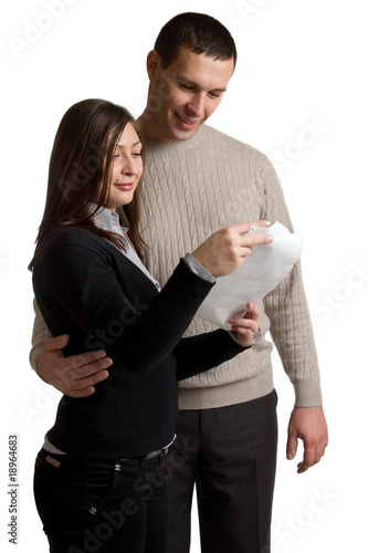 Happy young man and woman read letter.