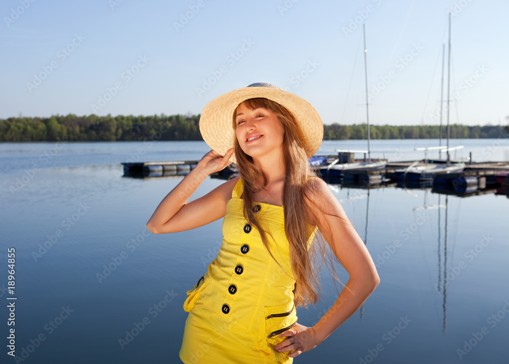 beautiful young woman on the sky and water background