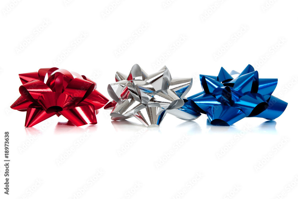 row of various colored christmas bows on white row of various colored christmas bows on white