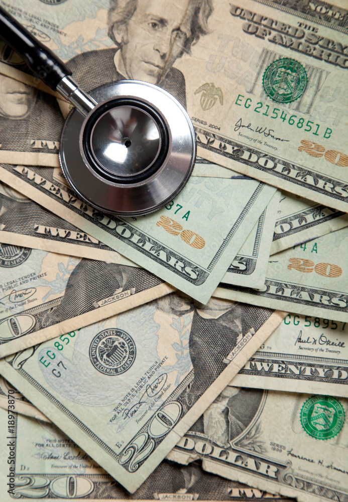 background of twenty dollar bills with a stethoscope background of twenty dollar bills with a stethoscope