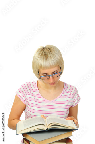 Young woman reading a book isolated on white