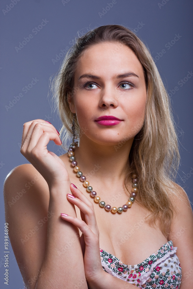Portrait of beautiful young woman with beads.