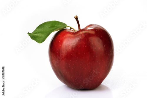 Ripe red apple with a leaf
