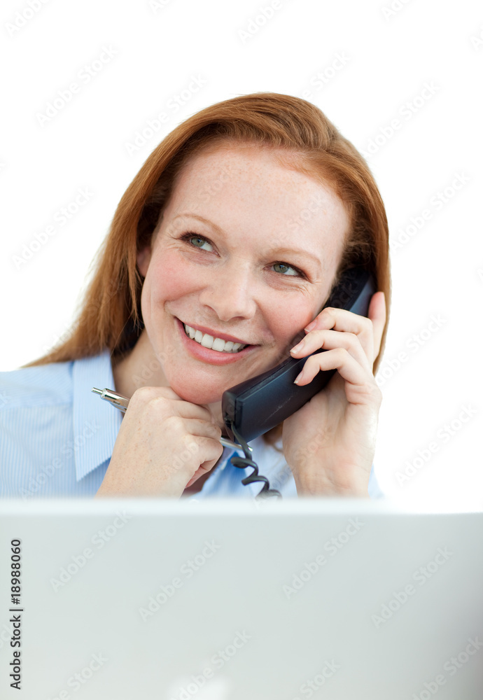 Businesswoman on phone at a computer Businesswoman on phone at a computer