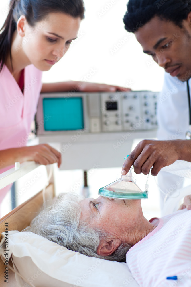 A doctor and a nurse resuscitating a patient A doctor and a nurse resuscitating a patient
