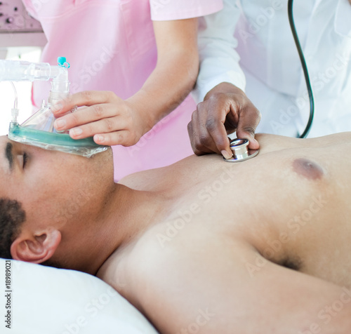 Patient receiving oxygen mask in an emergency unit