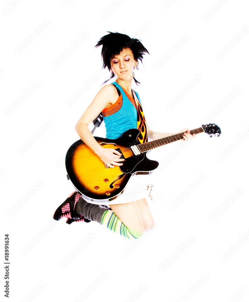 Young girl jumping with a guitar