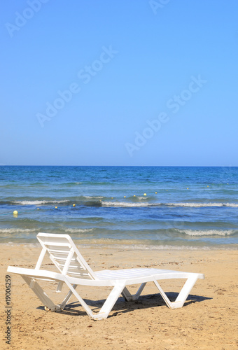 deckchairs on the beach © jordano