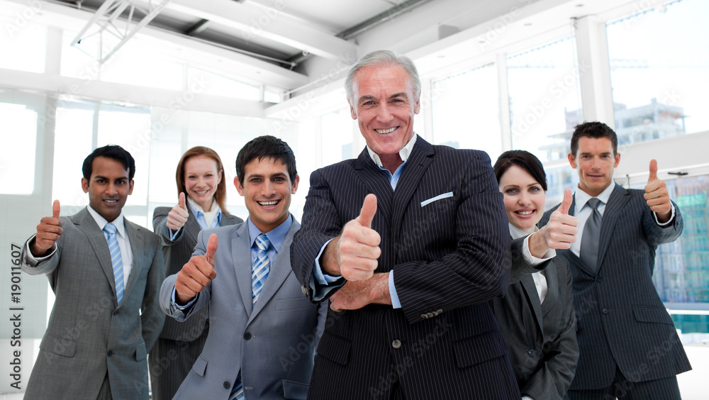 Happy multi-ethnic business team with thumbs up