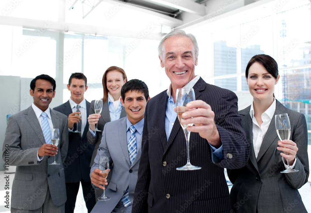 Happy diverse business group toasting with Champagne Happy diverse business group toasting with Champagne