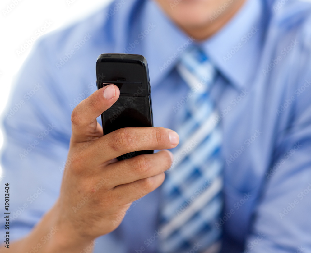 Close-up of a businessman sending a text Close-up of a businessman sending a text
