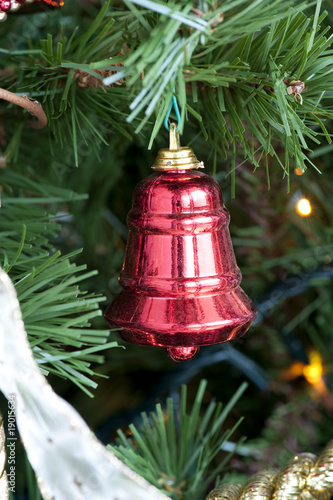 Detail of a decorative red bell on the Christmas tree © Tony