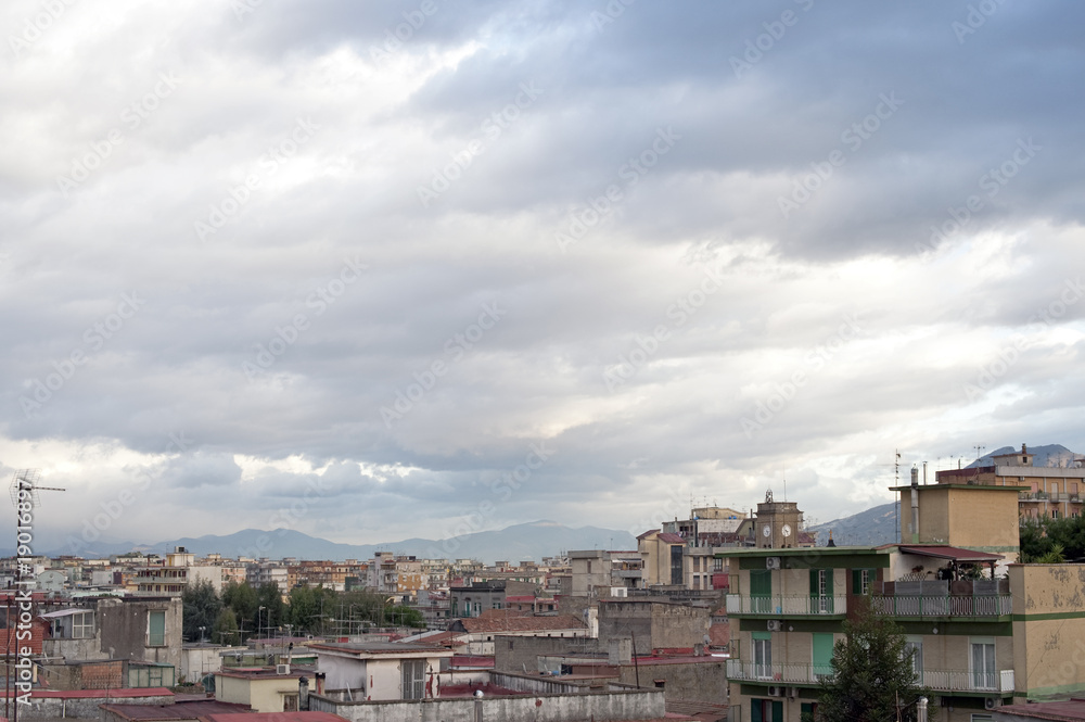 Sky and buildings with Vesuvius, Naples outskirts, Italy