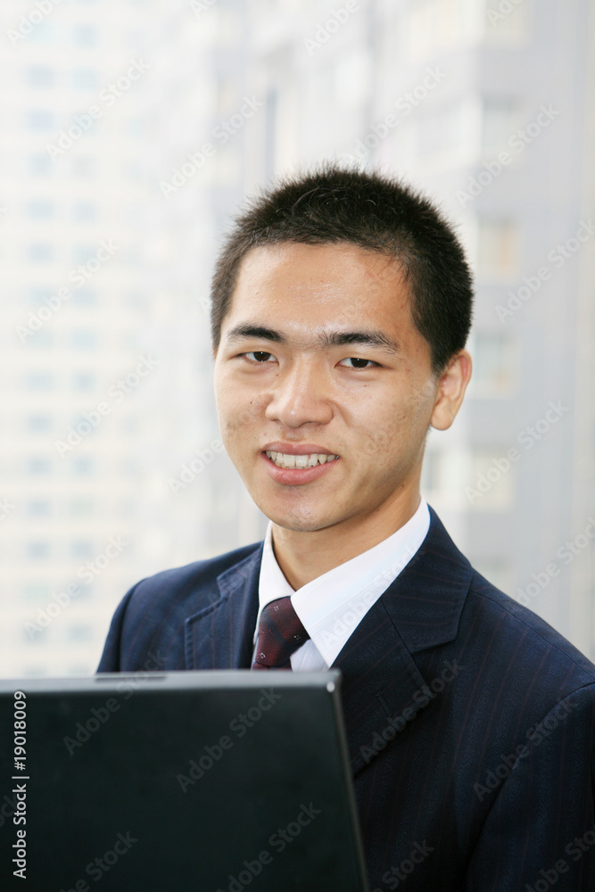 young asian businessman work with laptop in the office young asian businessman work with laptop in the office