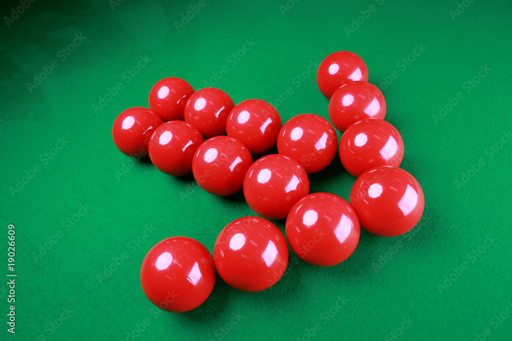 Red snooker balls with arrow shape on green background Red snooker balls with arrow shape on green background