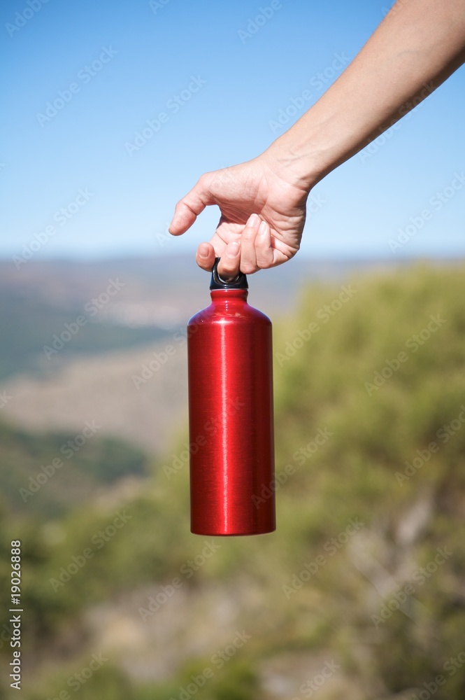 Obraz premium red bottle in hand