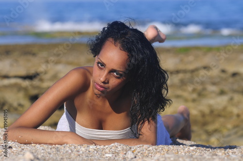 Portrait of pretty young woman on the beach photo