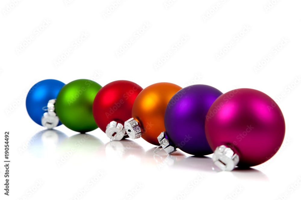 A row of assorted Christmas ornaments/baubles on white A row of assorted Christmas ornaments/baubles on white