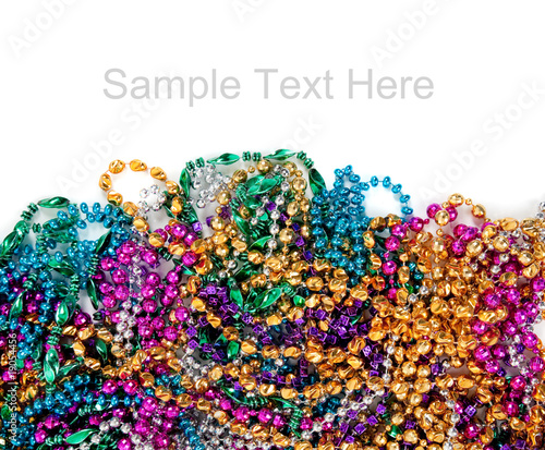 Mardi gras beads on white with copy space