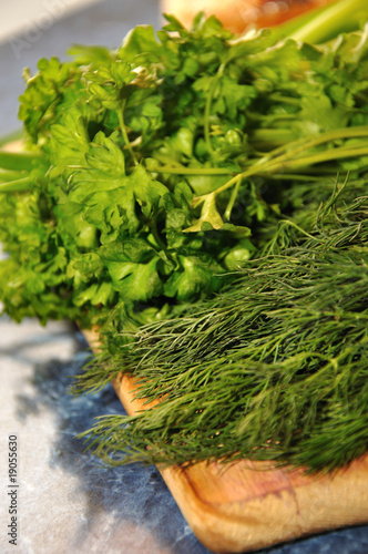 fresh green herbs on wood board
