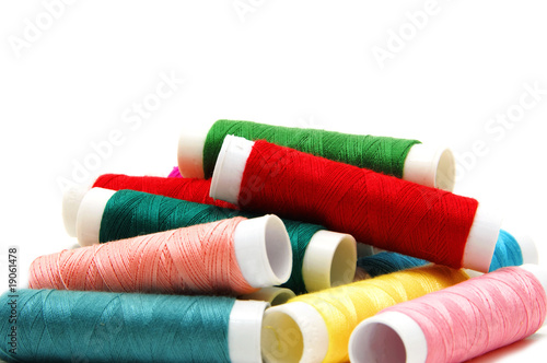 spools of many colors on a white background