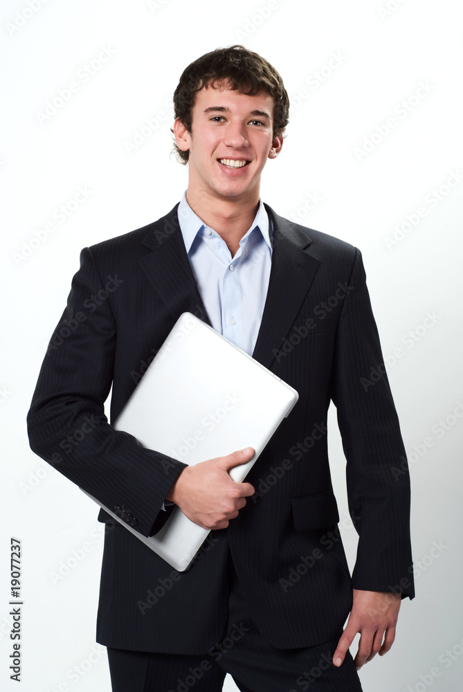 Young smiling businessman holding a laptop on white background Young smiling businessman holding a laptop on white background