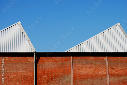 Old brick stone factory building with modern cladding
