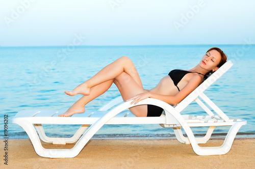 Beautiful woman sunbathing on the beach