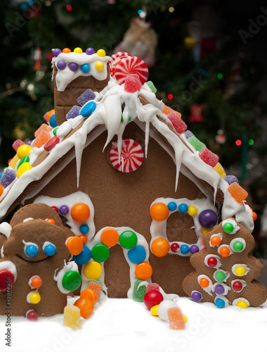 Gingerbread house and Christmas tree in the background