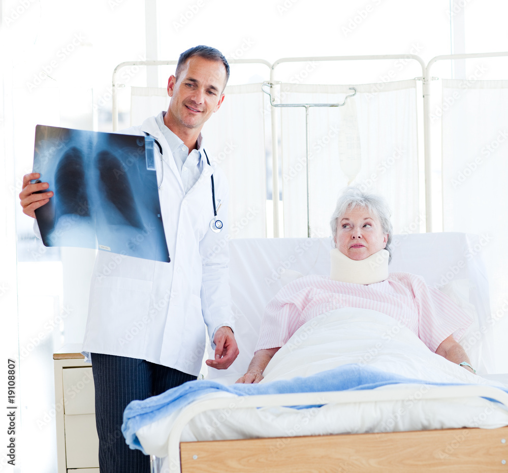 A doctor showing an x-ray to a patient A doctor showing an x-ray to a patient