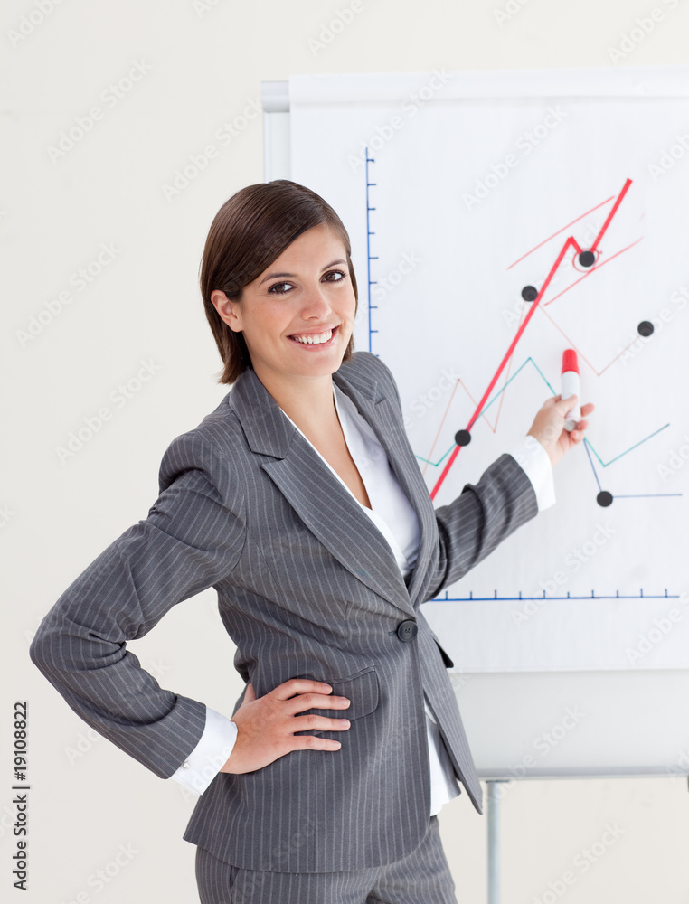 Smiling businesswoman reporting sales figures Smiling businesswoman reporting sales figures