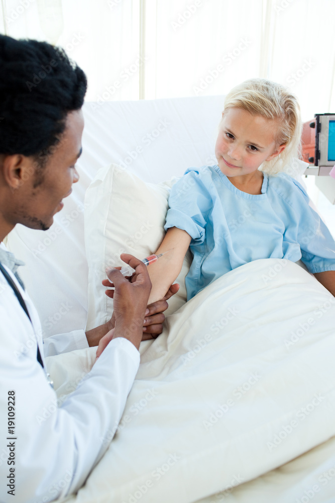 Male doctor giving a child patient an injection Male doctor giving a child patient an injection