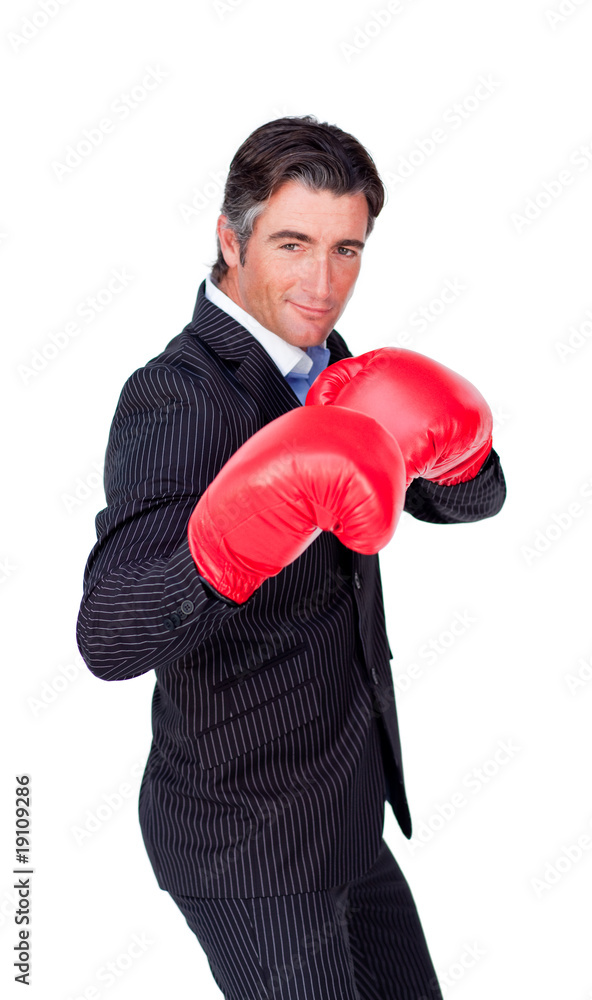 Confident businessman wearing boxing gloves Confident businessman wearing boxing gloves