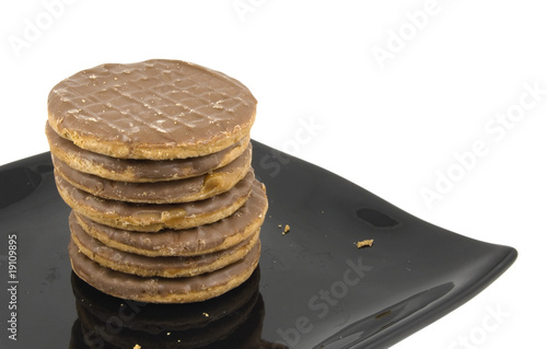 stack of chocolate biscuits / cookies on black plate photo