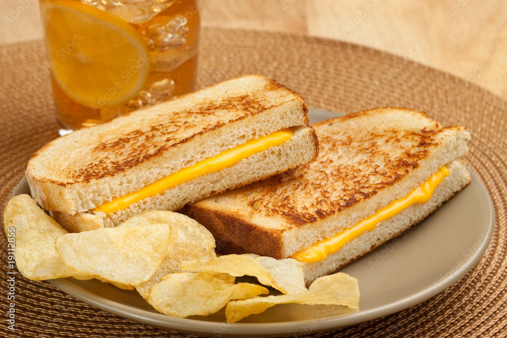 Grilled cheese sandwich, potato chips, glass of iced tea Stock Photo