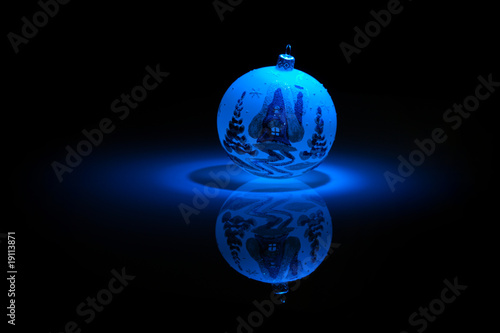 Blue Snowflake bauble on black background.
