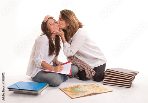 Mother kissing her teen dau...