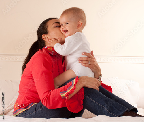 Mom kissing her baby