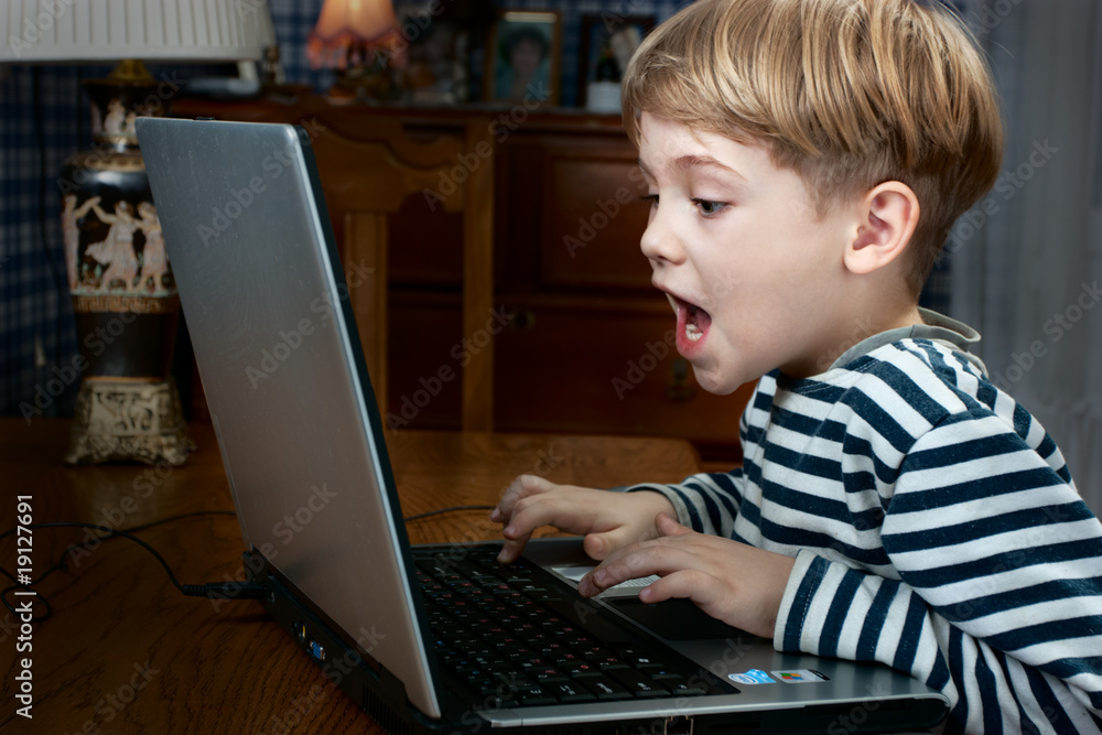 boy playing computer game boy playing computer game