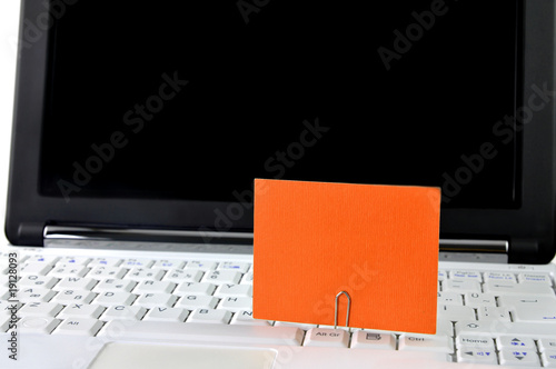 Modern laptop with blank card on it
