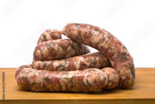 Raw sausages on a chopping board