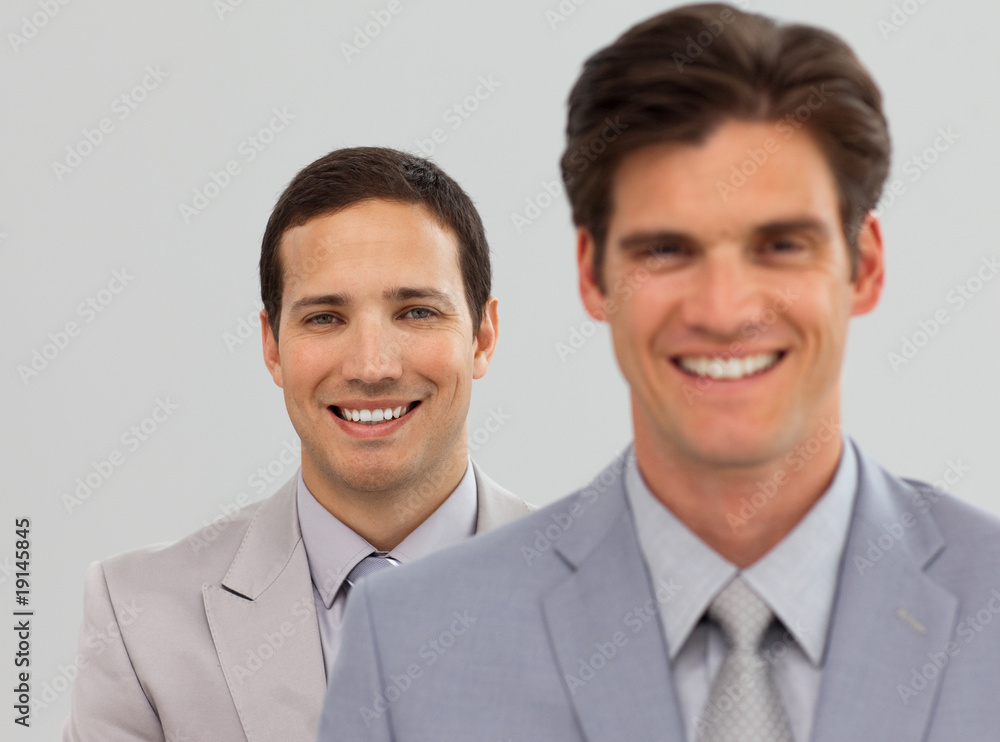 Two Business associates standing in a line Two Business associates standing in a line