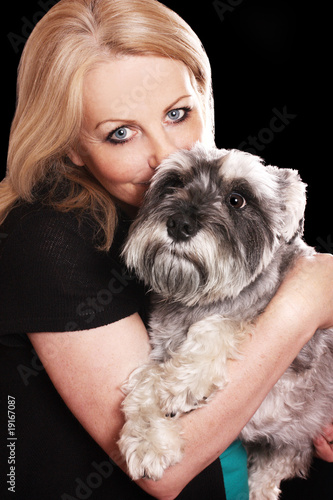 Woman kissing her dog