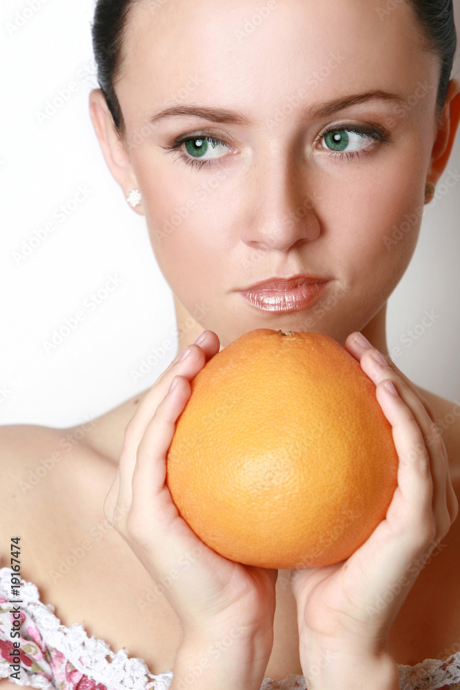 Beautiful woman's face with grapefruit Beautiful woman's face with grapefruit