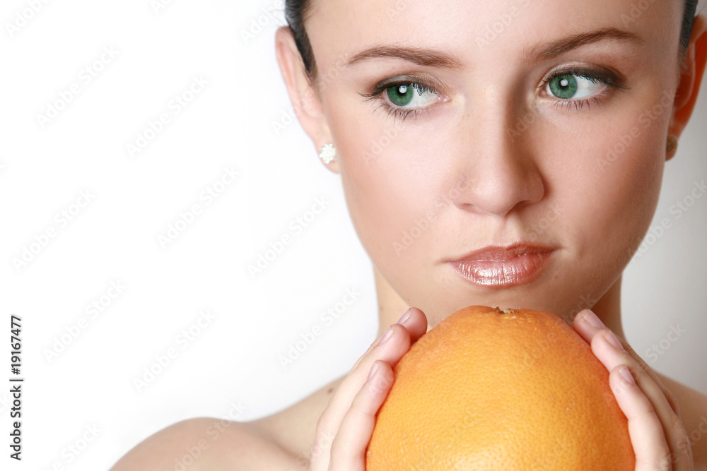 Beautiful woman's face with grapefruit Beautiful woman's face with grapefruit