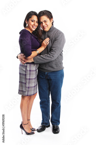 Full body picture of hispanic couple hugging isolated