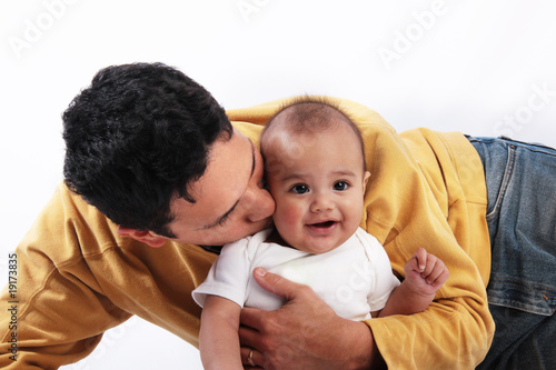 Father kissing baby son